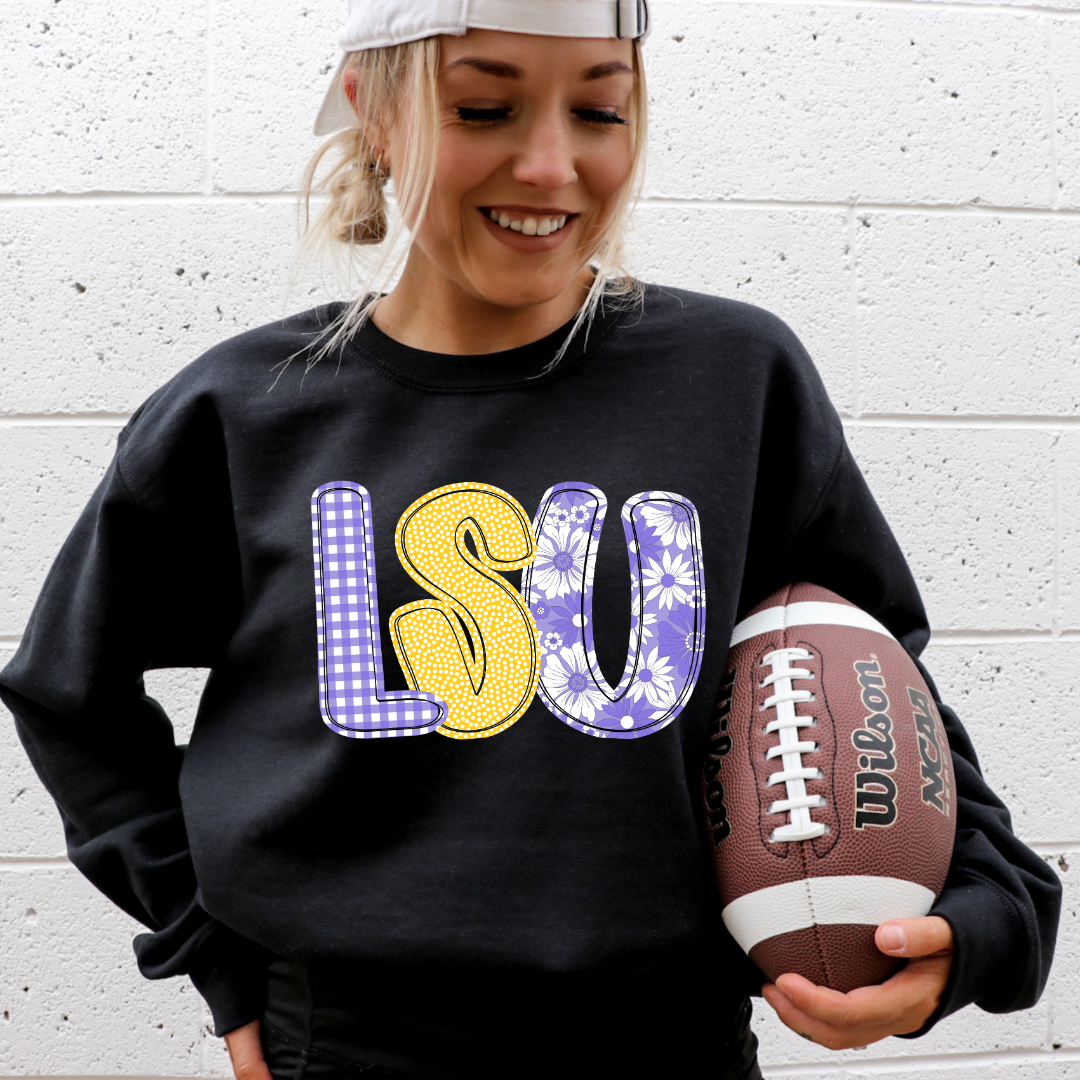 Person wearing a black sweatshirt with 'LSU' 