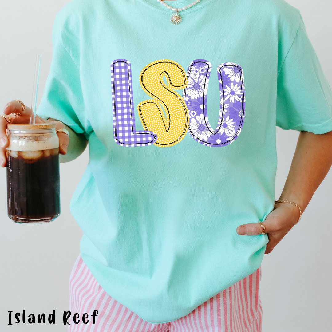 Person wearing a light blue t-shirt with 'LSU' 