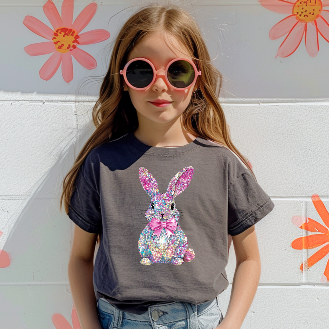 Young girl wearing a gray t-shirt with a colorful bunny design, 