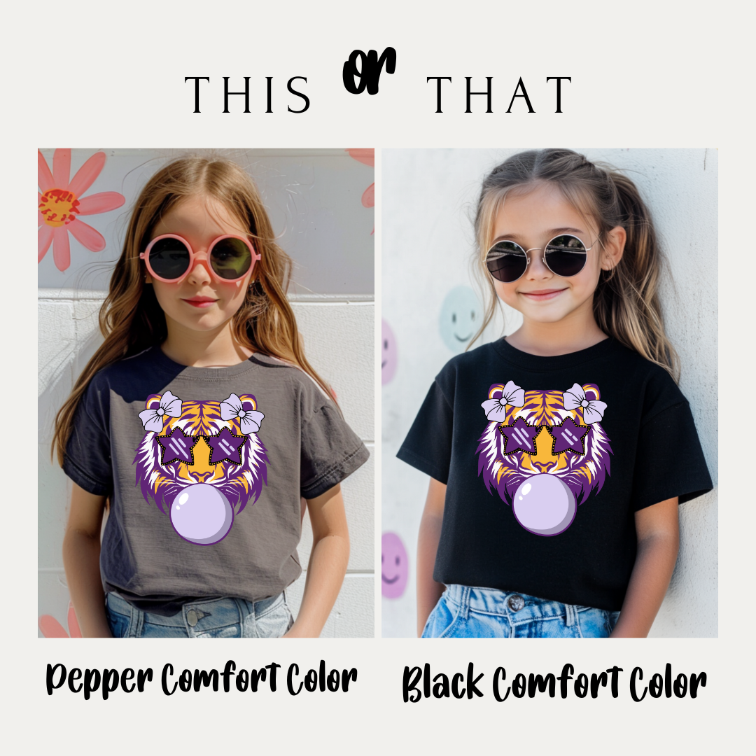 Two children wearing t-shirts with a tiger design, one in pepper comfort color and one in black comfort color.