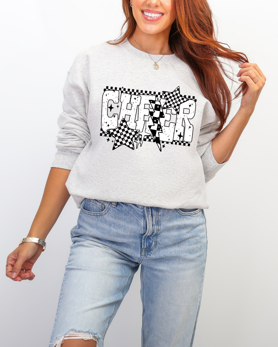 Person wearing a gray sweatshirt with 'CHEER' design on a plain background